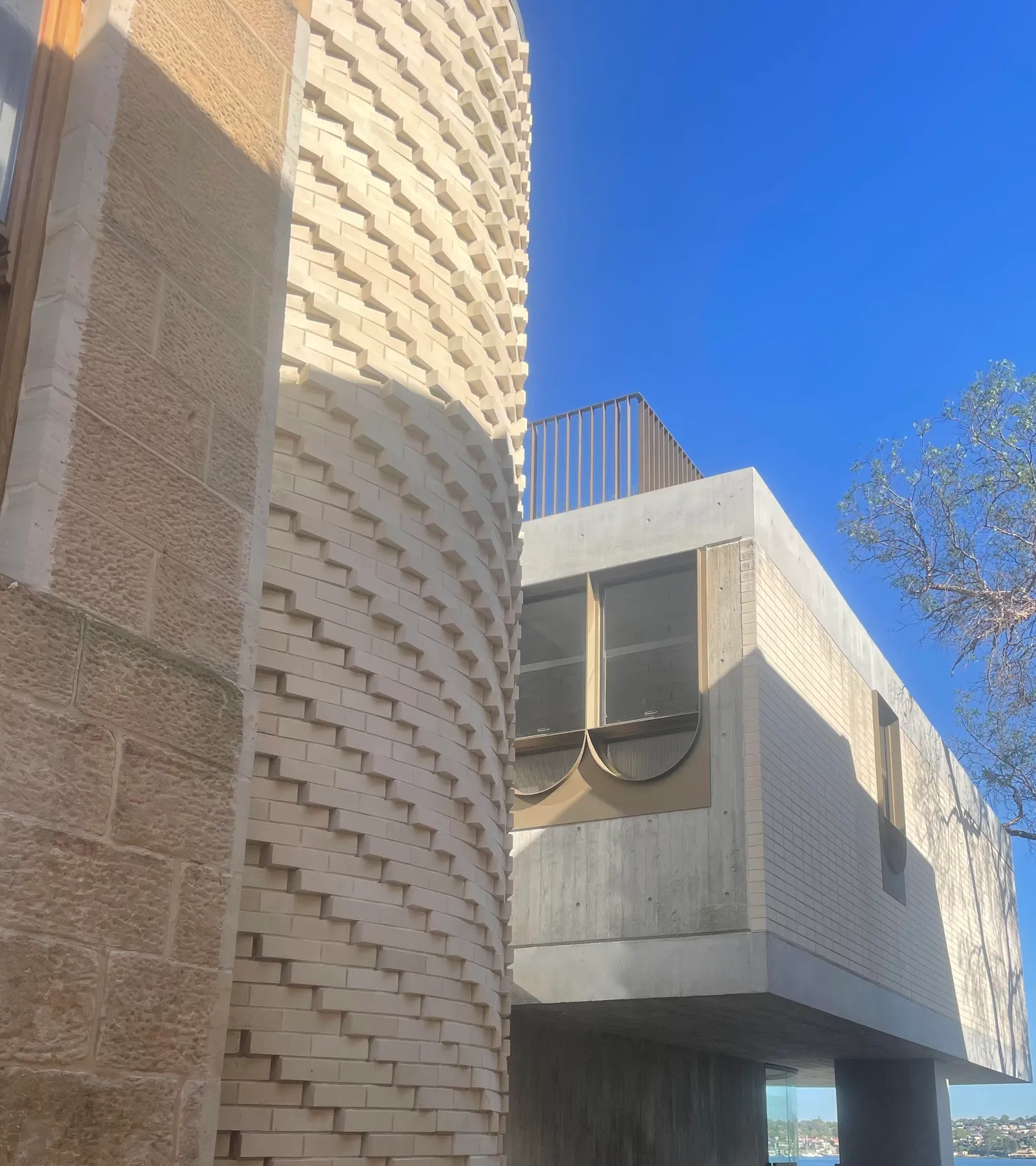 Modern building with a curved cream brick facade