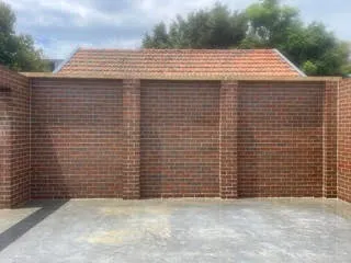 Three bay brick garage with clean brickwork and mortar joints