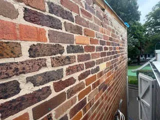 Close-up of mixed red and dark brickwork with clean mortar joints