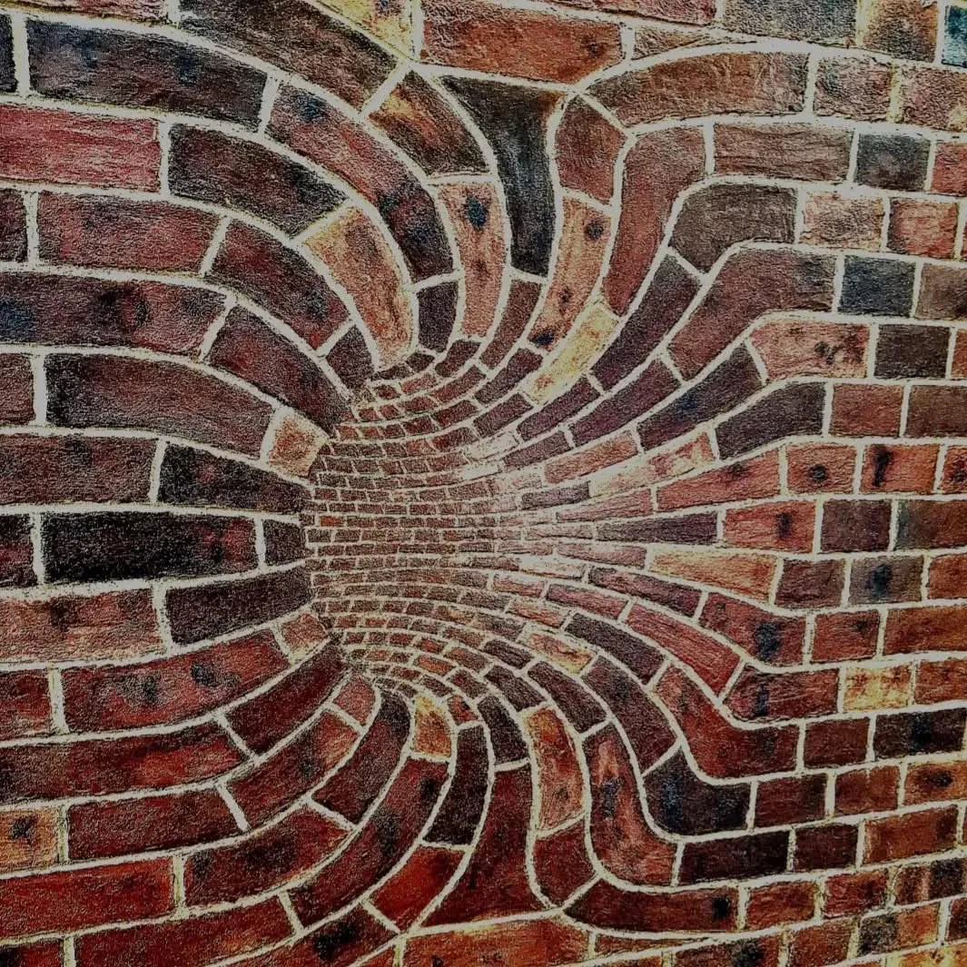 Circular sunburst feature brickwork in red and brown brick, cleaned