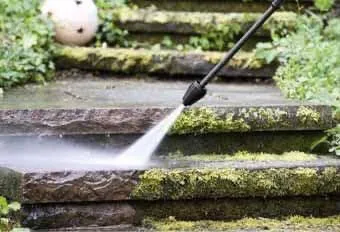 Pressure washing moss and lichen from weathered sandstone steps